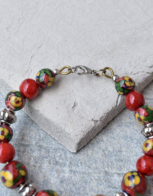 Handmade Round Bracelet With Blue Pottery Beads, Metal Beads & Hook in Red Colour Base With Yellow Flower